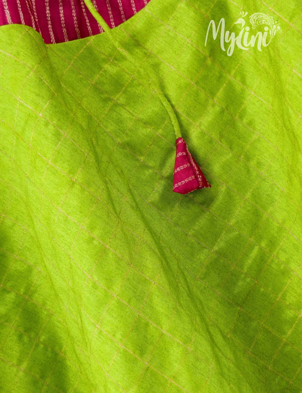 Close-up of a green fabric with a pink decorative element, branded 'MyLini'.