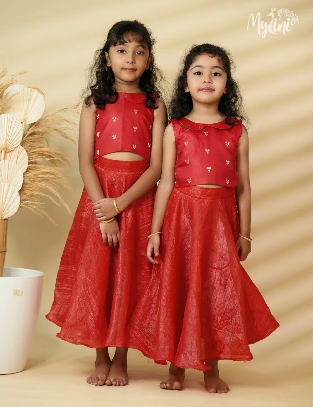 Young girl wearing a red traditional outfit with a beige background