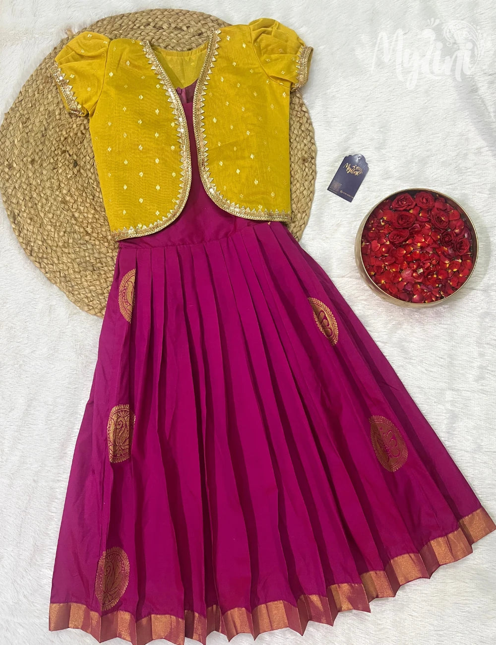 Purple dress with yellow embroidered jacket on a textured white background