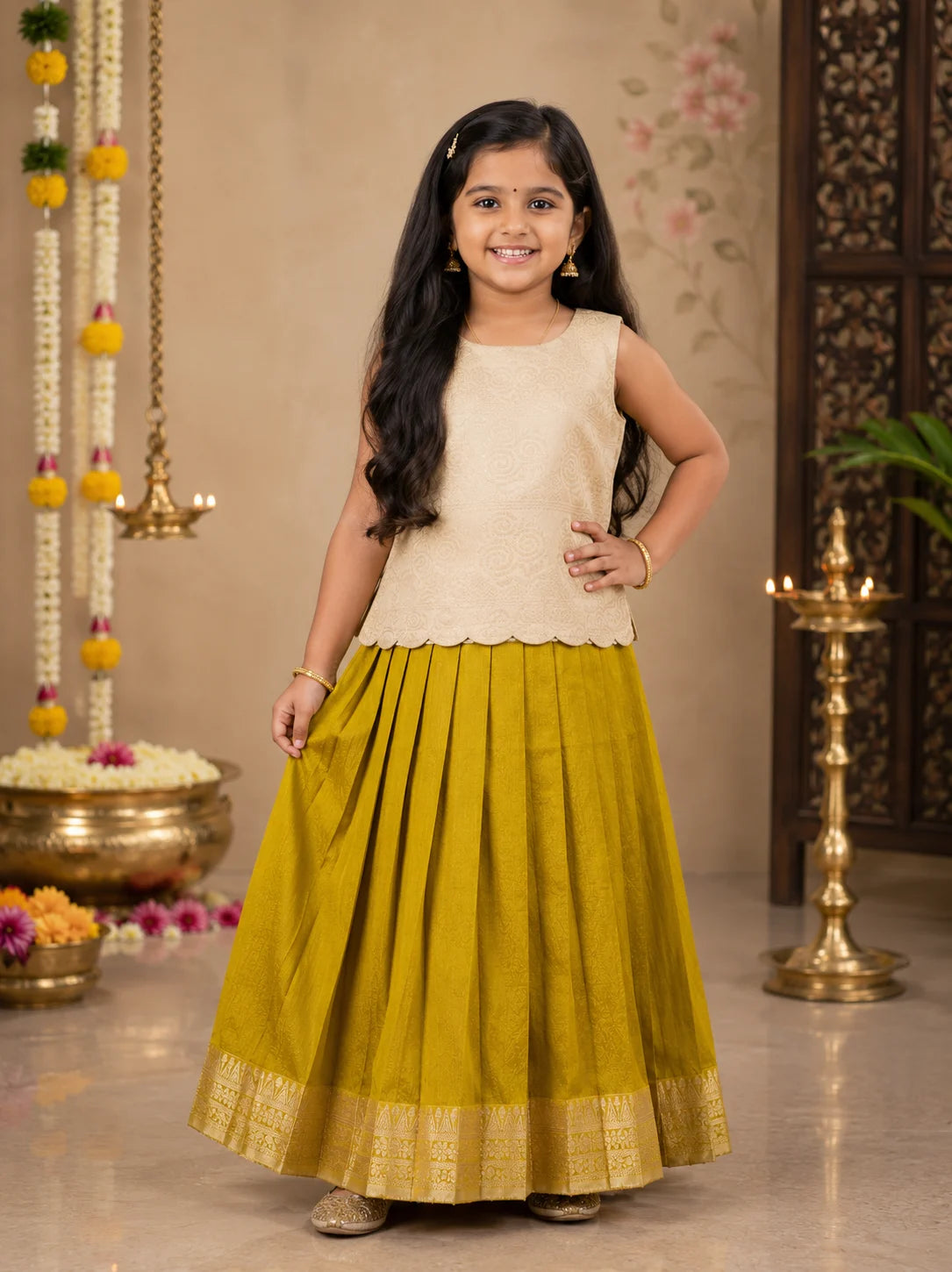 Young girl in a beige top and green skirt standing in a decorated indoor setting.