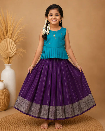 Young girl in a blue top and purple skirt standing on a brown floor with decorative elements.
